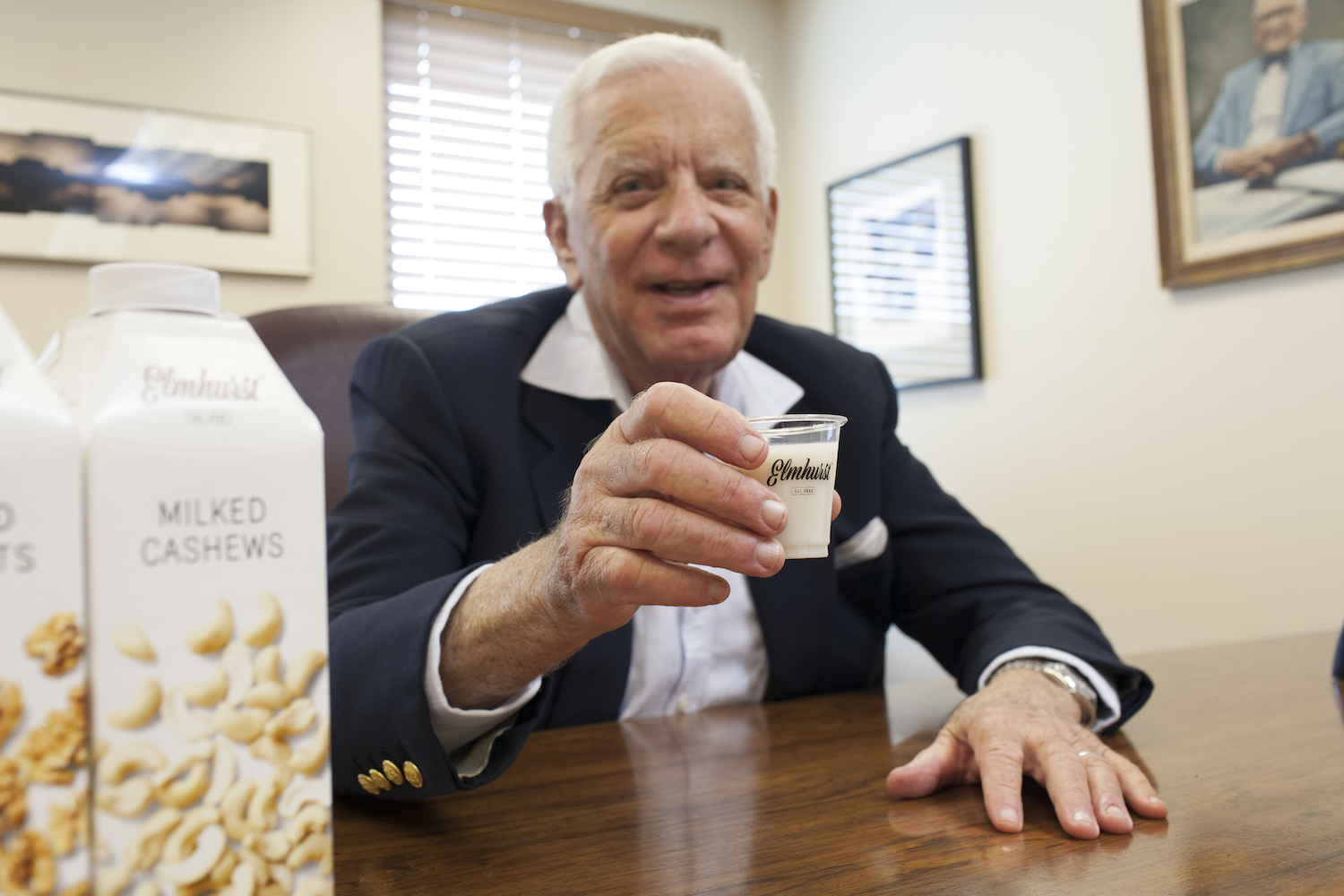 Elmhurst Milked's CEO Henry Schwartz with a glass of their nut milk.