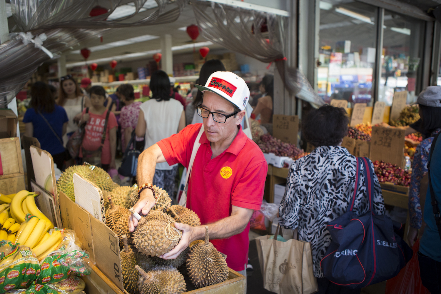 Joe DiStefano picking up a durian at Queens market.