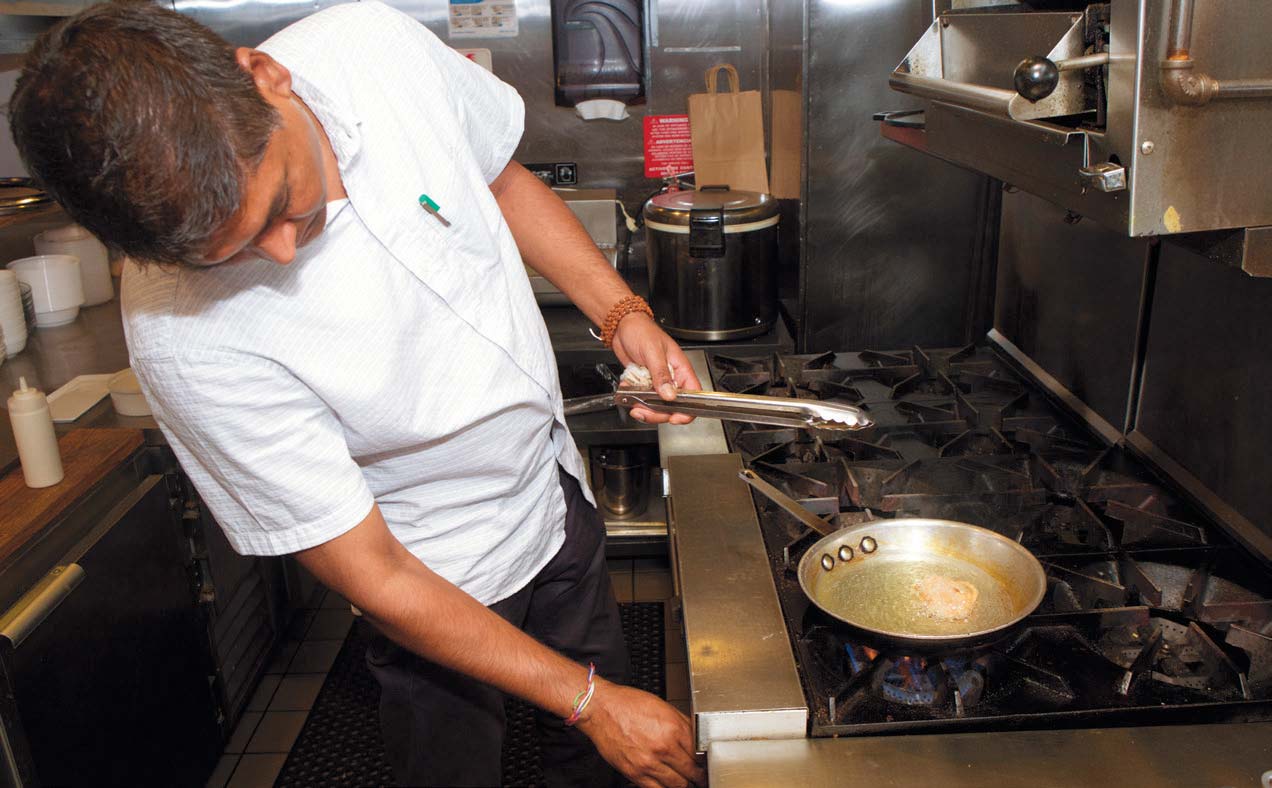 Sonny Solomon of Kurry Qulture making jalebis at his restaurant in Astoria.