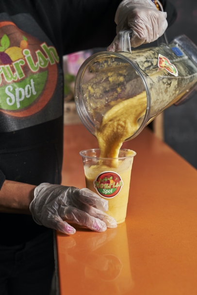 Smoothie being poured at The Nourish Spot in Jamaica, Queens, New York.
