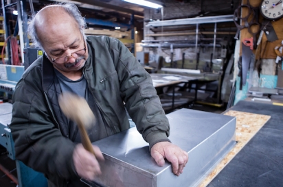 Sheetmetal worker Nestor Lugo of 800BuyCart builds a stainless steel bain-marie for a food cart.