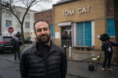 Tom Cat Bakery workers and other supporters stand against ICE crackdown.