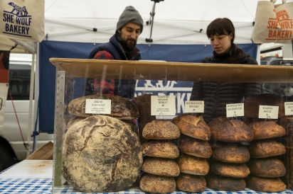 vShe Wolf Bakery’s Nick Cregor and a customer at Forest Hills’ Sunday Greenmarket in Queens, New York,
