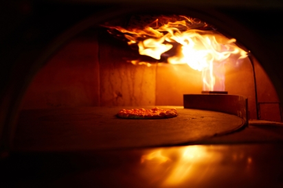 The cheery red wood and gas-fired Forni oven at Beebe's in Long Island City, Queens, New York.