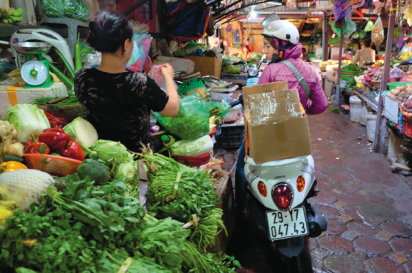 A shopper goes to market on her scooter in Hanoi, Vietnam.