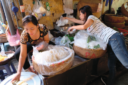 Hands-on lessons in rolling fresh spring rolls called Phở Cuốn in Hanoi, Vietnam.