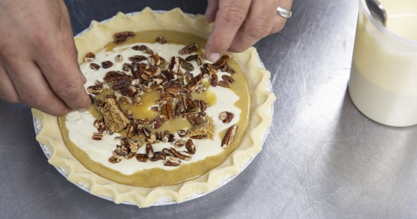 Mignano assembling his holiday pecan pie and cardamom-ginger cheesecake hybrid at Farine Baking Company in Jackson Heights, Queen.