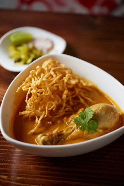A tempting bowl of khao soi with chicken, creamy coconut curry and crispy noodle at Lamoon Thai in Elmhurst, Queens New York.