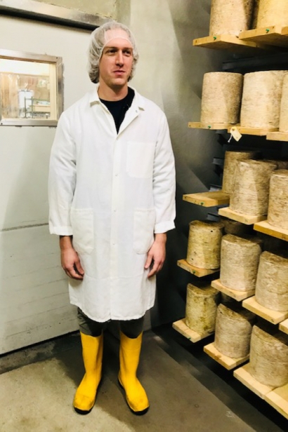 Cavemaster Peter Jenkelunas surrounded by cylinders of Stockinghall Cheddar, Murray’s first house-made cheese.