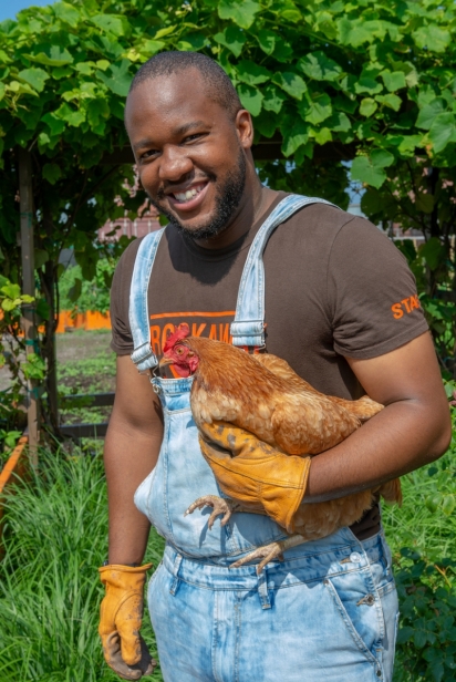 Founder Milan Taylor with a chicken from the RYTF flock in Rockaway, Queens.