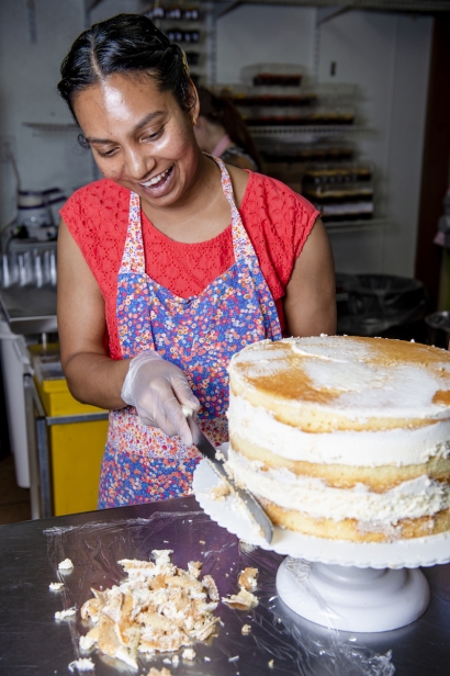 Mahalo Bakery's in Glendale Sunita Shiwdin prepping a cake prior to decorating it.