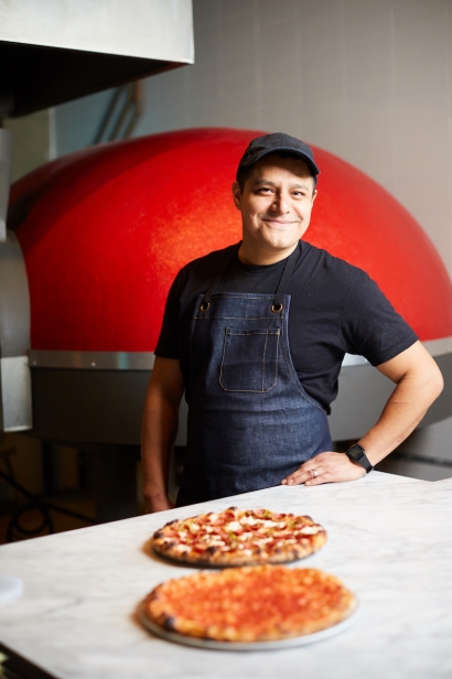 Beebe's pizzaiolo Pascual Gonzalez standing by the Forni oven in the restaurant in Long Island City, Queens.