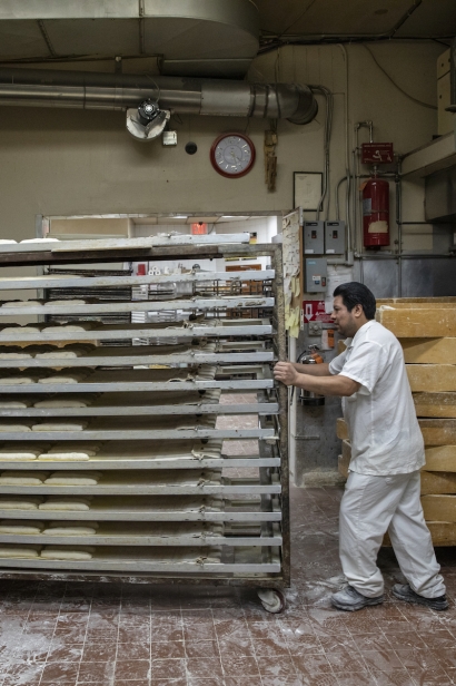 Loading the proofer with shaped loaves at Gian Piero Bakery in Astoria, Queens, New York.limoncello eclairs at Gian Piero;