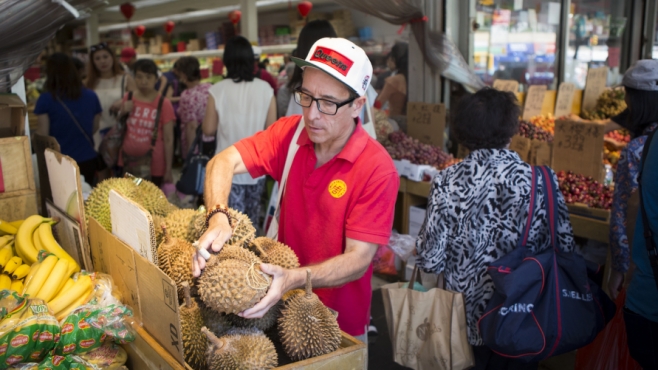 Joe DiStefano picking up a durian at Queens market.